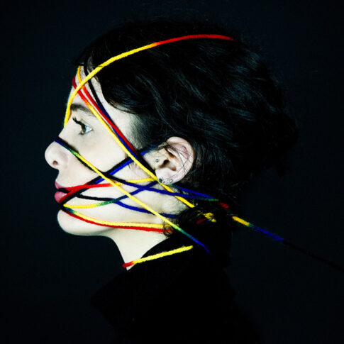 artistici female portrait with colored yarn profile