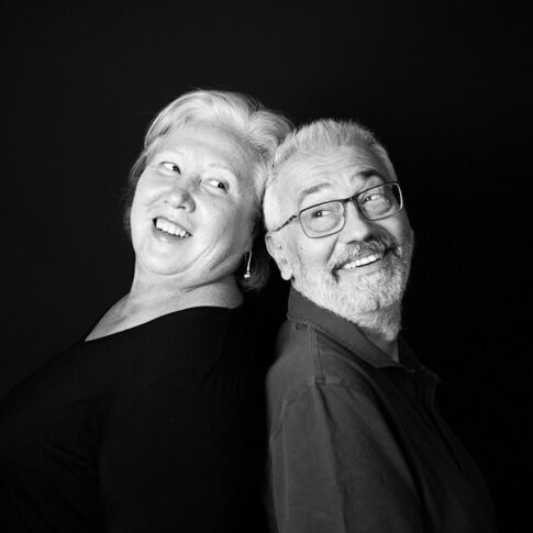 laughing couple in black and white portrait