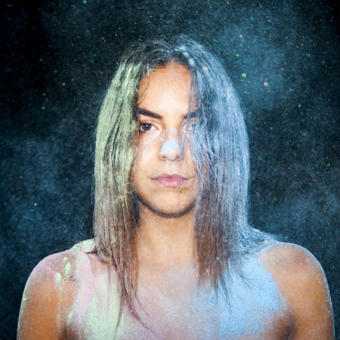 artistic portrait of female in colorful flour explosion by Jenny Liedholm